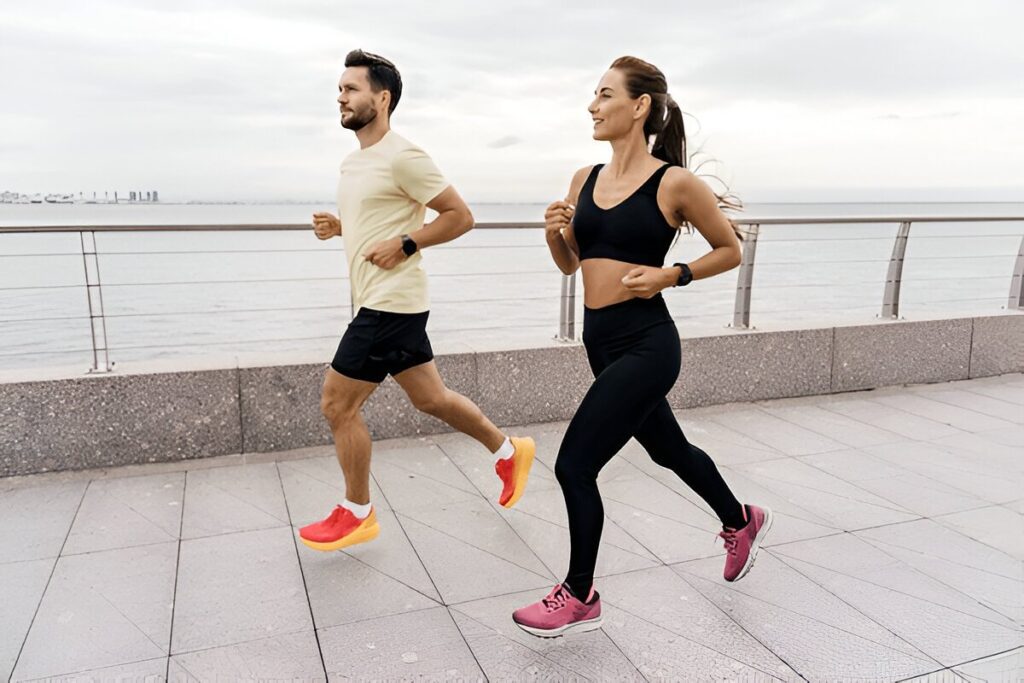 A person and person running on a beach