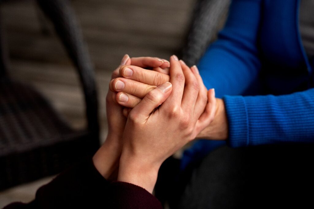 A close-up of hands holding each other